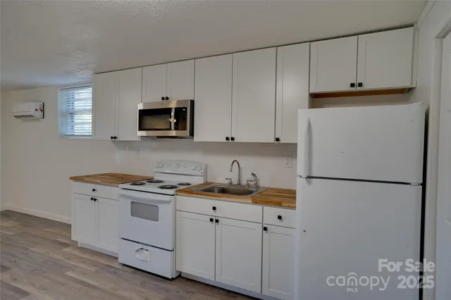a kitchen with cabinets appliances and a window