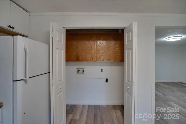 a view of hallway with wooden floor