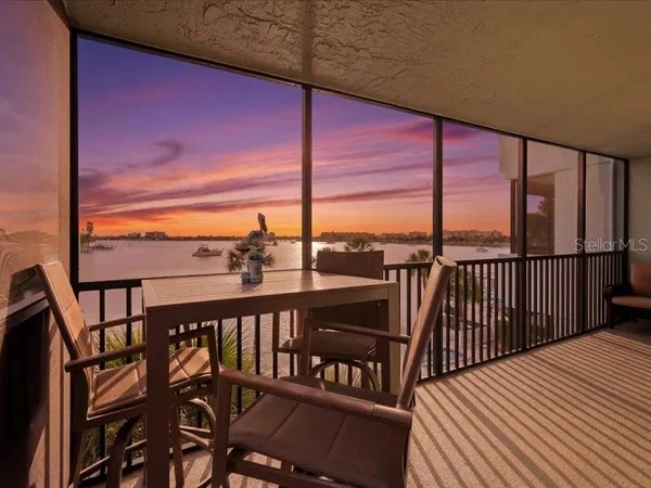 a view of a balcony with furniture and city view
