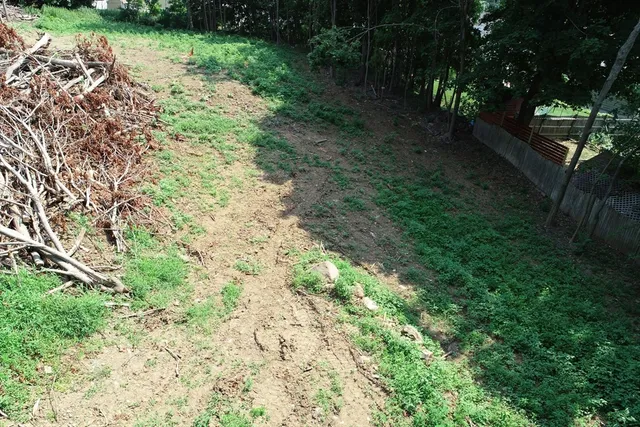 an aerial view of a house with yard