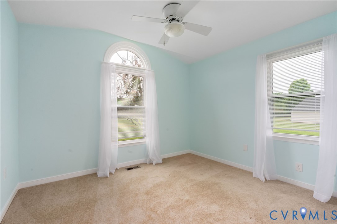 16379 Arch Hill Road Hanover, VA 23069 - Photo 11 of 26 an empty room with windows and a chandelier fan