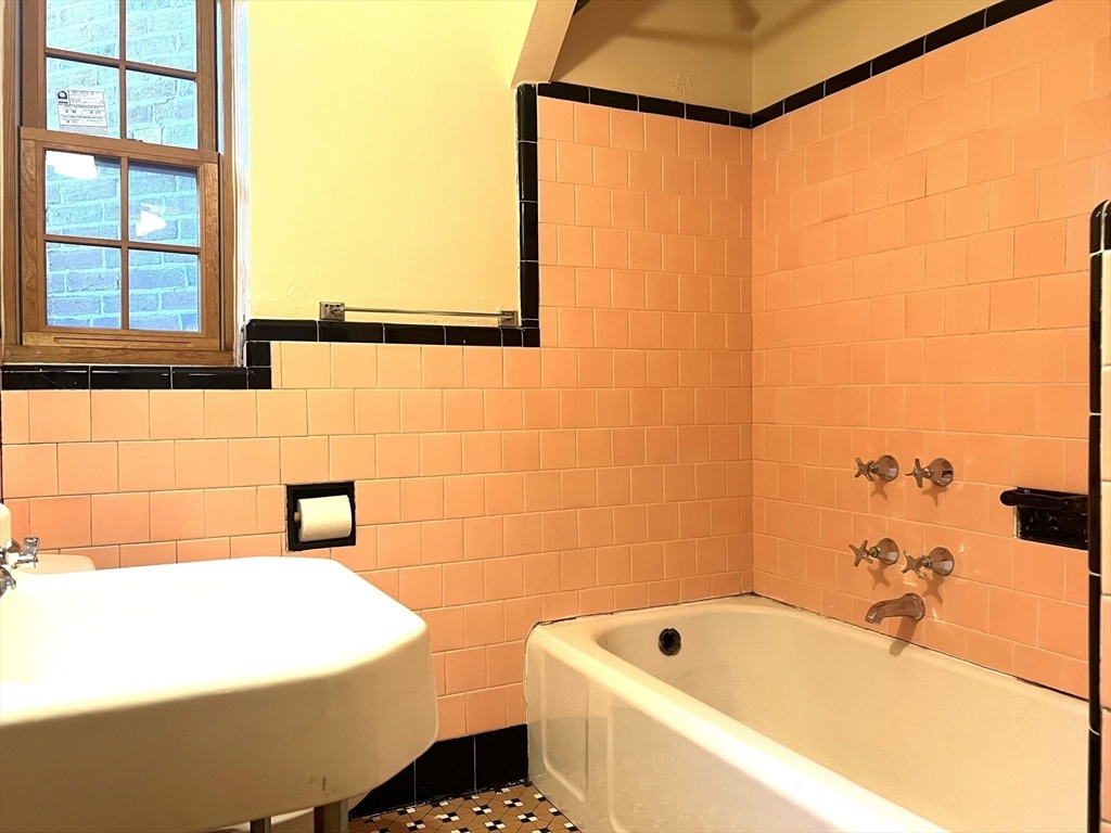 10 Presidents Lane, Unit 10 Quincy, MA 02169 - Photo 11 of 15 a bathroom with a bathtub and shower