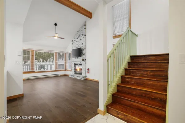 a view of entryway and hall with wooden floor