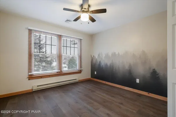 wooden floor in an empty room with a window