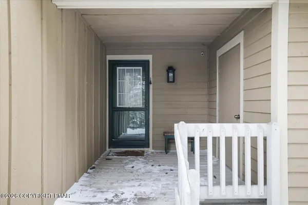 a view of a porch with a table and chair