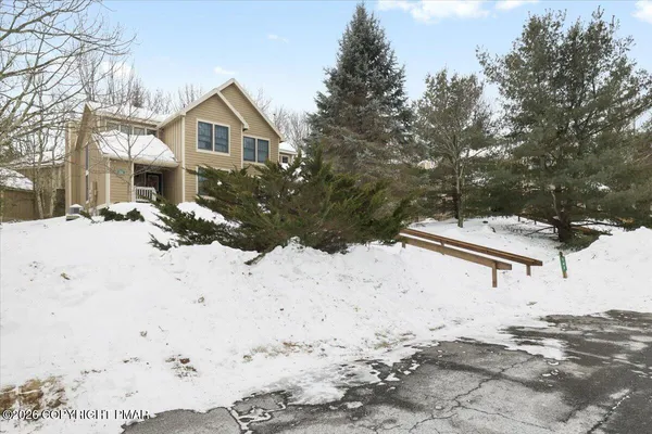 a view of a house with snow on the road