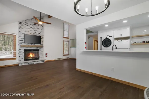 an entryway with fireplace and wooden floor