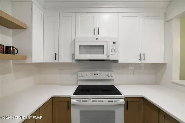 a kitchen with a stove and a microwave