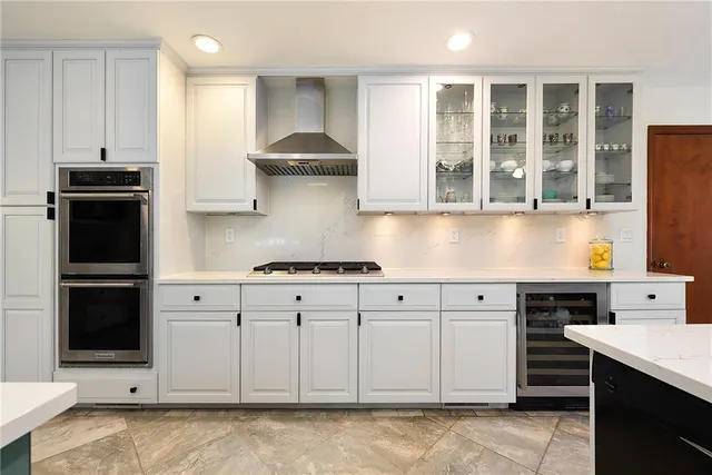 a kitchen with stainless steel appliances granite countertop a stove and a refrigerator