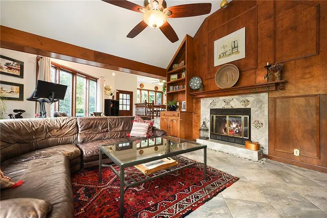 a living room with furniture a flat screen tv and a fireplace