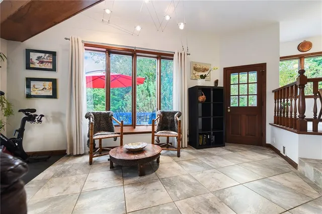a living room with furniture a window and a fireplace