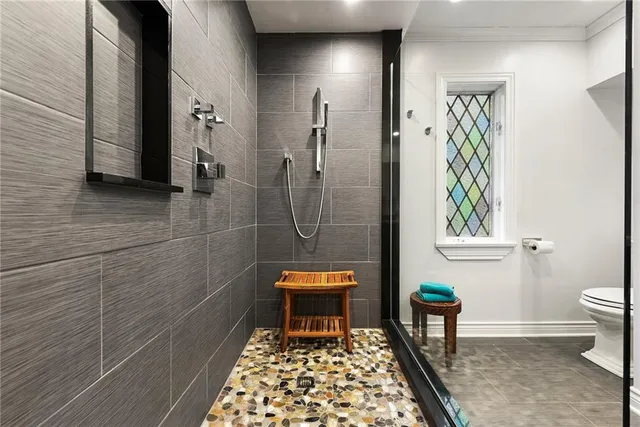 a bathroom with a toilet and a shower