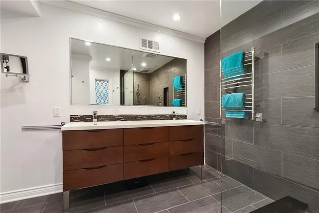 a bathroom with a double vanity sink and a mirror