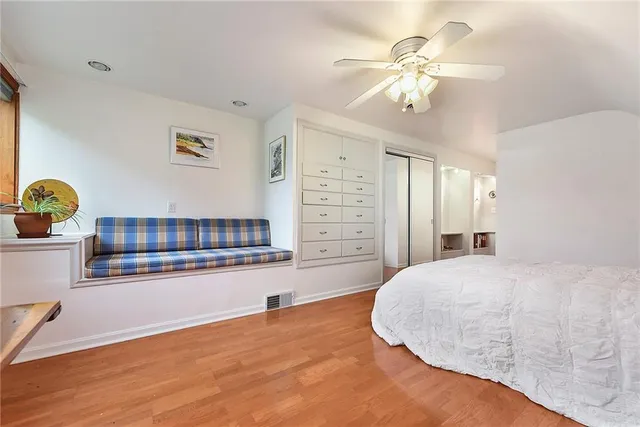 a spacious bedroom with a bed and a chandelier