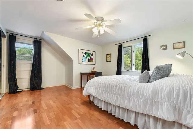 a bedroom with a large bed and a chandelier