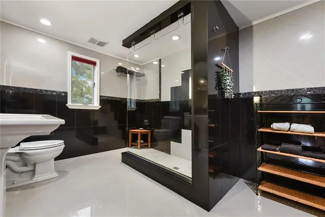 a bathroom with a toilet a sink and mirror