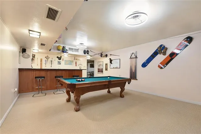 a room with furniture and air hockey table