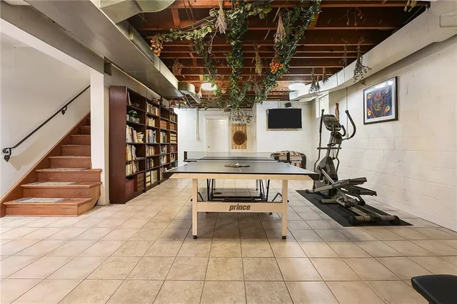 a room with gym equipment and a rug