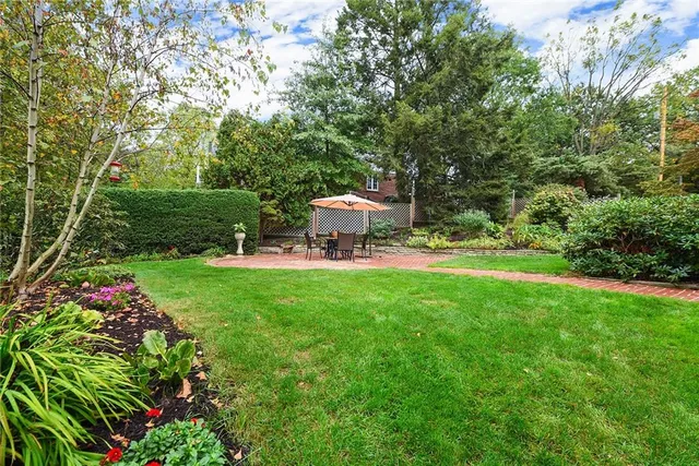 a view of a backyard with plants and outdoor seating
