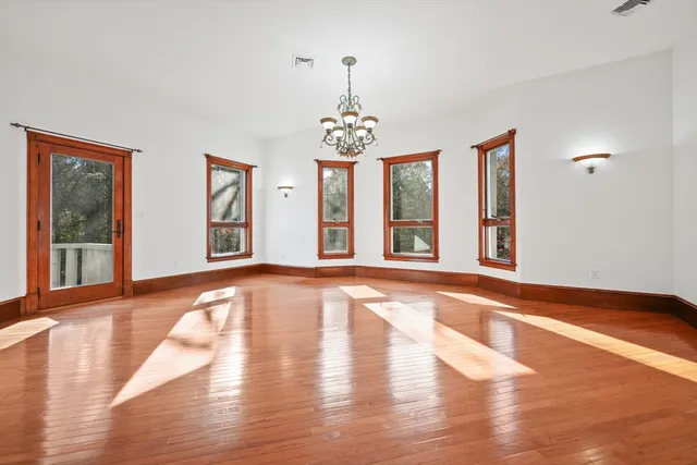 a view of an room with wooden floor and windows