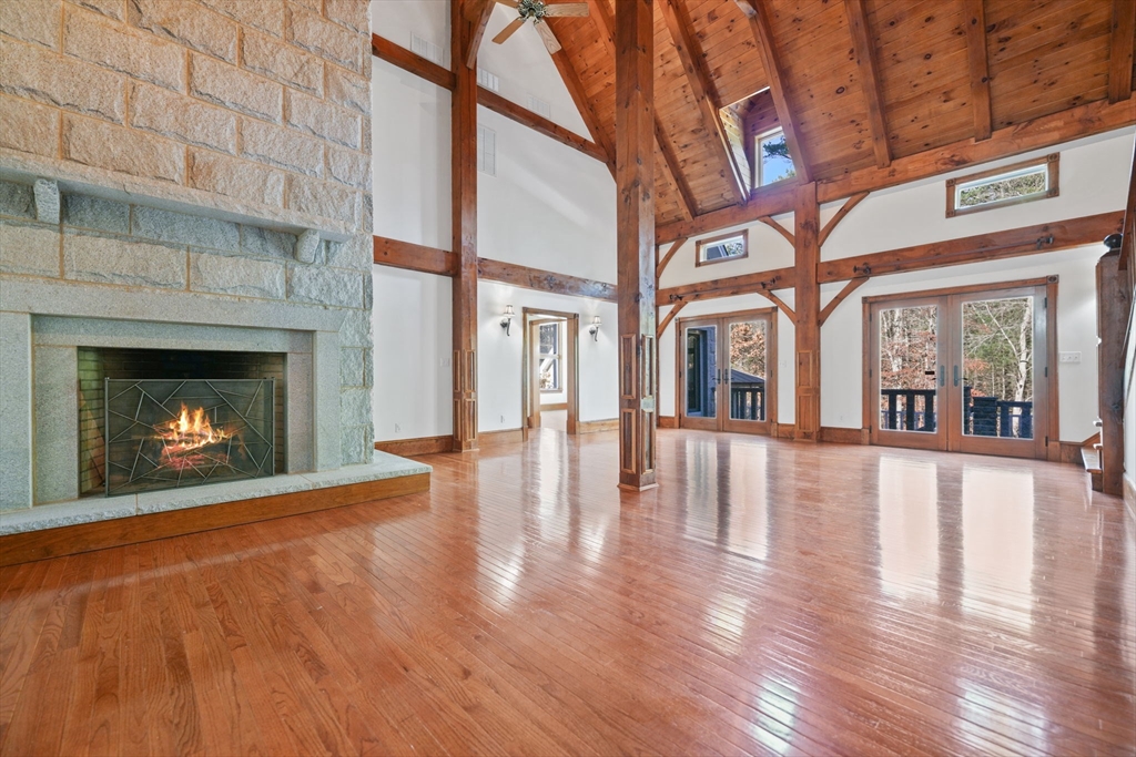 219 Chase Road Dartmouth, MA 02747 - Photo 12 of 42 a view of an empty room with wooden floor fireplace and a window