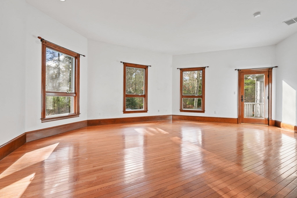 219 Chase Road Dartmouth, MA 02747 - Photo 17 of 42 a view of an empty room with window and wooden floor