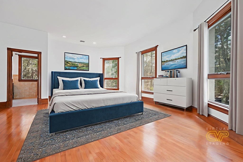 219 Chase Road Dartmouth, MA 02747 - Photo 24 of 42 a spacious bedroom with a bed and a painting on the wall