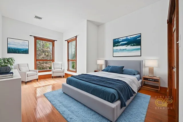 a bedroom with a large bed couch and a window