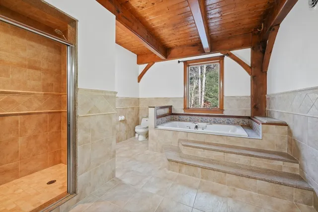 a spacious bathroom with a tub and shower