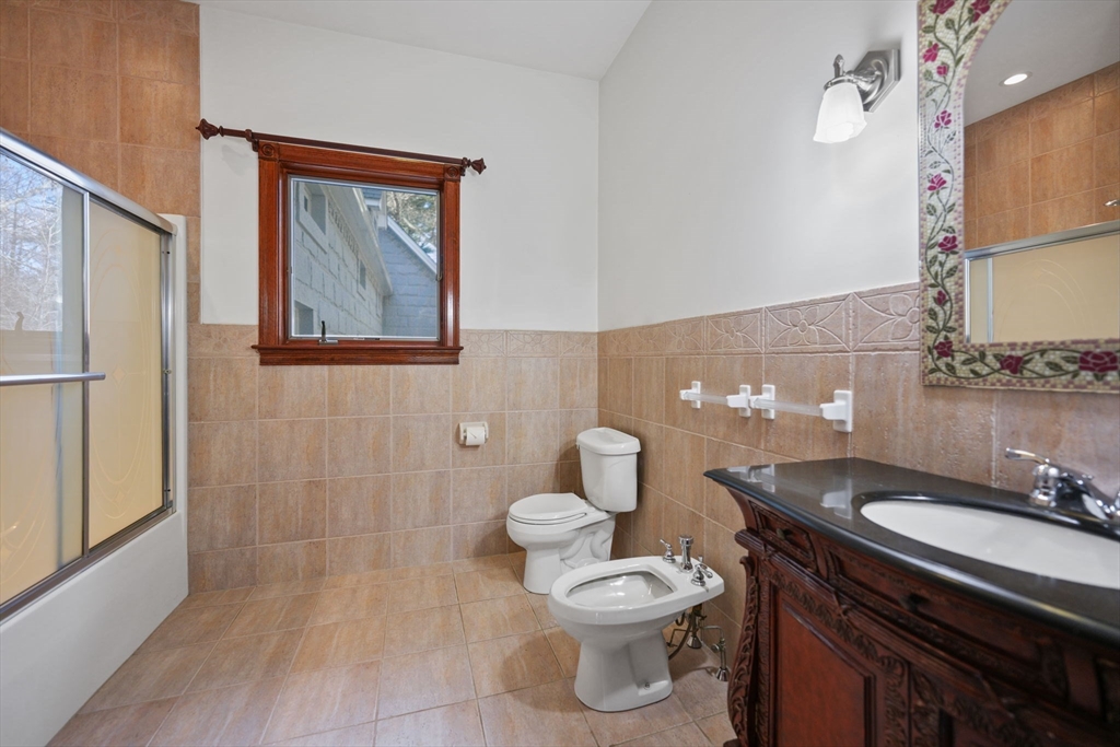 219 Chase Road Dartmouth, MA 02747 - Photo 27 of 42 a bathroom with a granite countertop toilet sink and mirror