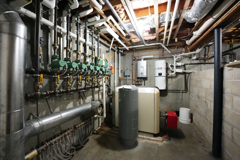 219 Chase Road Dartmouth, MA 02747 - Photo 32 of 42 a room with water heater and racks