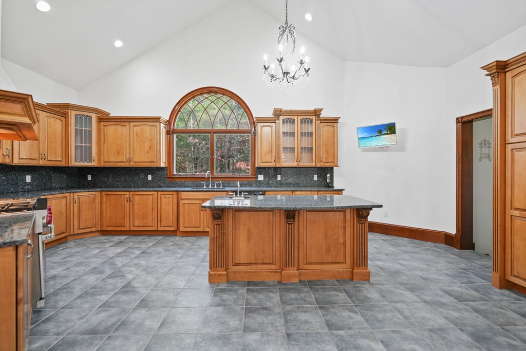219 Chase Road Dartmouth, MA 02747 - Photo 9 of 42 a view of spacious kitchen with granite countertop cabinets and flat screen tv