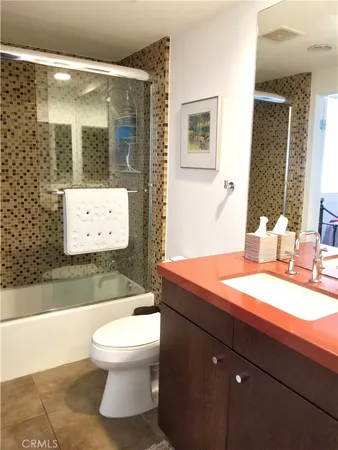 a bathroom with a sink a toilet and mirror