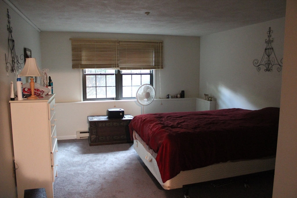 24 Spencer Road, Unit 12N Boxborough, MA 01719 - Photo 4 of 7 a bedroom with a bed and window