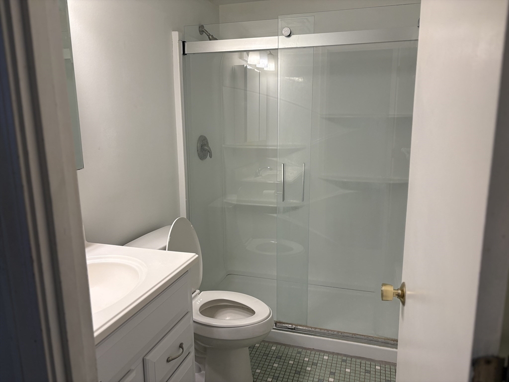24 Spencer Road, Unit 12N Boxborough, MA 01719 - Photo 6 of 12 a bathroom with a granite countertop sink toilet and shower