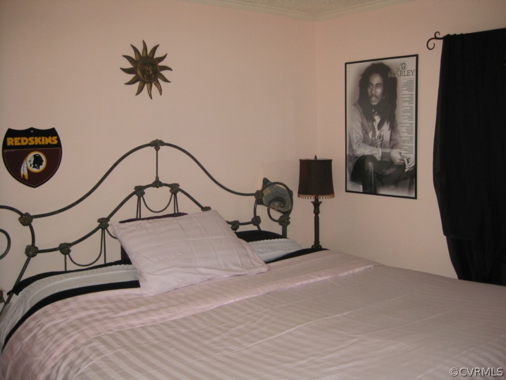4520 Plank Road Kenbridge, VA 23944 - Photo 7 of 13 a bedroom with a bed and a mirror