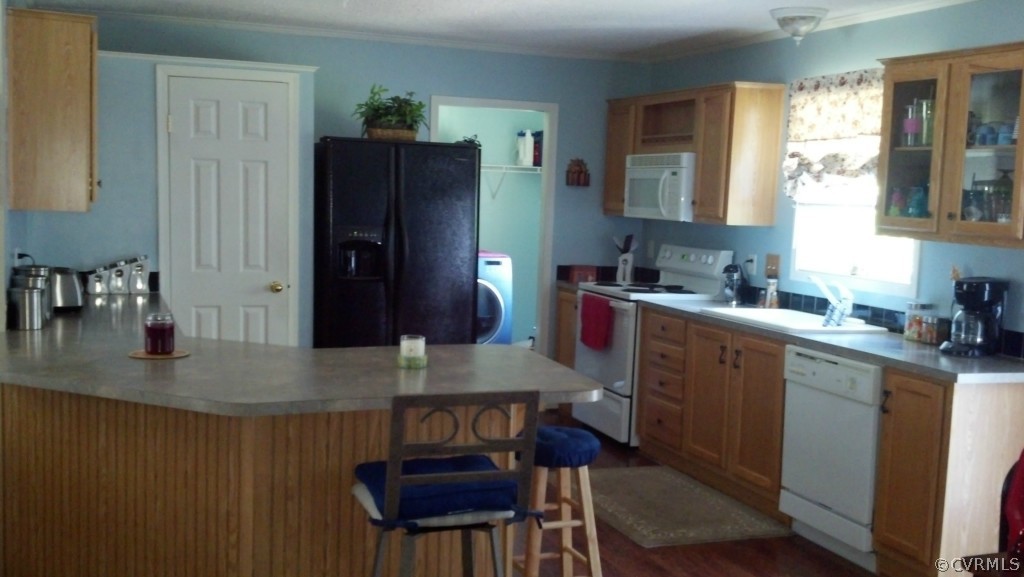 4520 Plank Road Kenbridge, VA 23944 - Photo 8 of 13 a kitchen with a table chairs and refrigerator