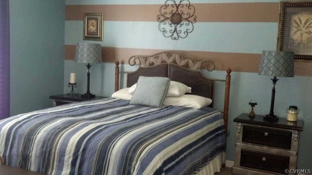 4520 Plank Road Kenbridge, VA 23944 - Photo 10 of 13 a bedroom with a bed and a chandelier