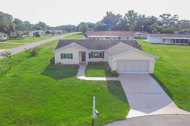 a aerial view of a house with a yard table and chairs