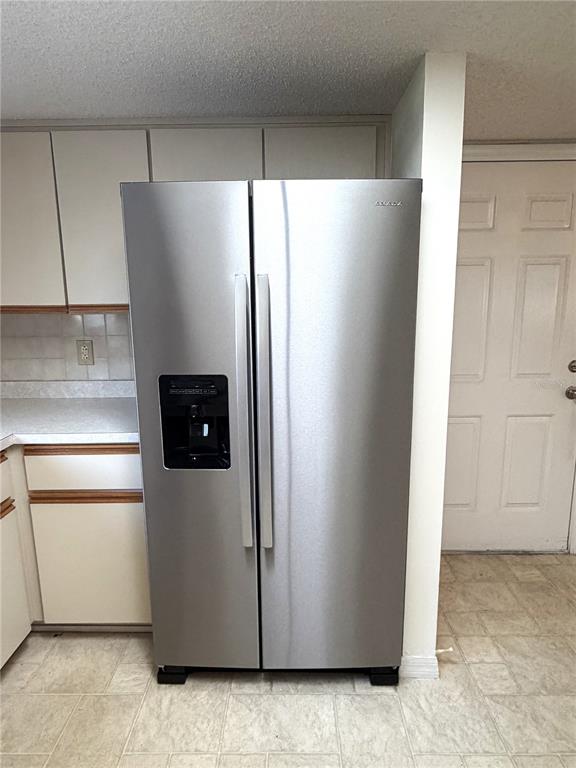 10980 Southwest 62nd Avenue Ocala, FL 34476 - Photo 12 of 48 a view of a refrigerator in kitchen and an empty room