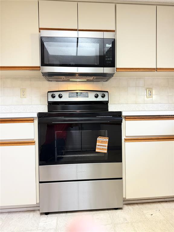 10980 Southwest 62nd Avenue Ocala, FL 34476 - Photo 14 of 48 a stove top oven sitting inside of a kitchen