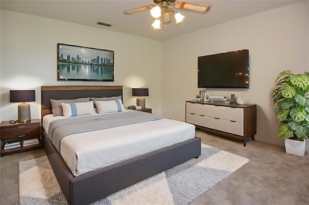 10980 Southwest 62nd Avenue Ocala, FL 34476 - Photo 17 of 48 a bedroom with a large bed and a flat screen tv