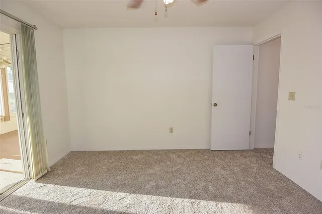a view of a large room with wooden floor and windows