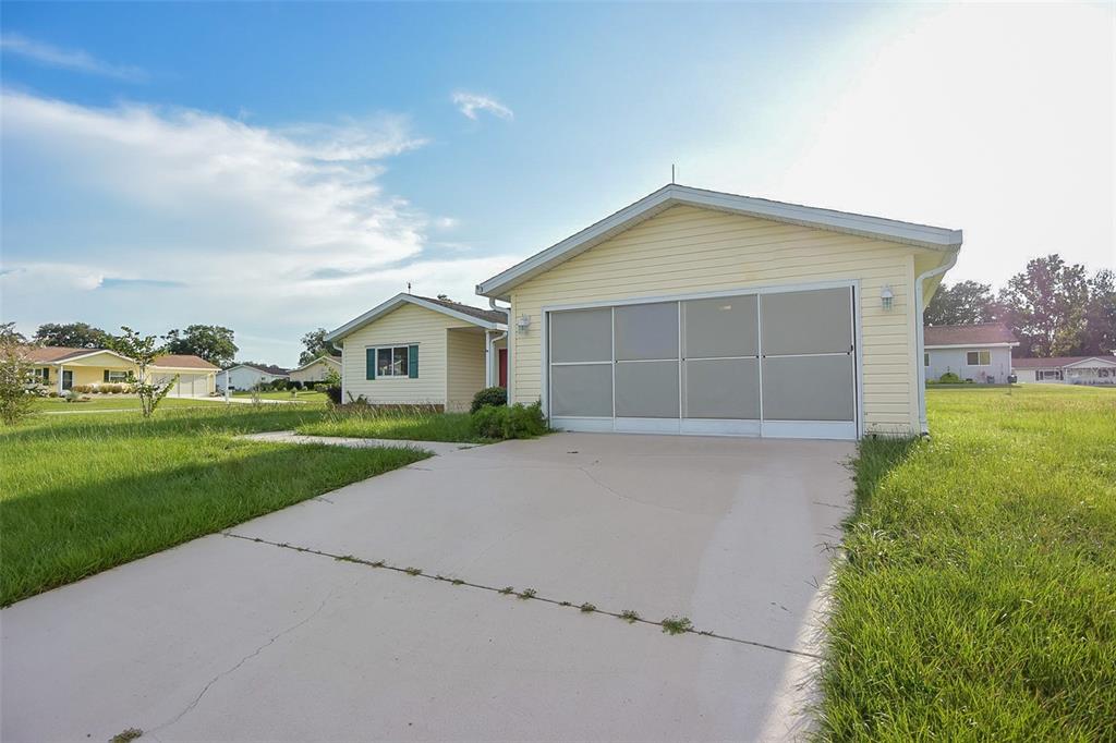 10980 Southwest 62nd Avenue Ocala, FL 34476 - Photo 37 of 48 a view of house with a yard and garage