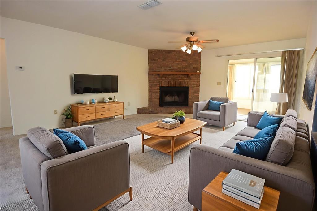 10980 Southwest 62nd Avenue Ocala, FL 34476 - Photo 4 of 48 a living room with furniture a fireplace and a flat screen tv