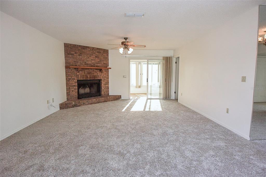10980 Southwest 62nd Avenue Ocala, FL 34476 - Photo 5 of 48 an empty room with windows and fireplace