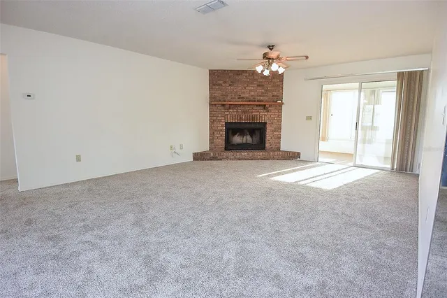 a view of an empty room with a fireplace