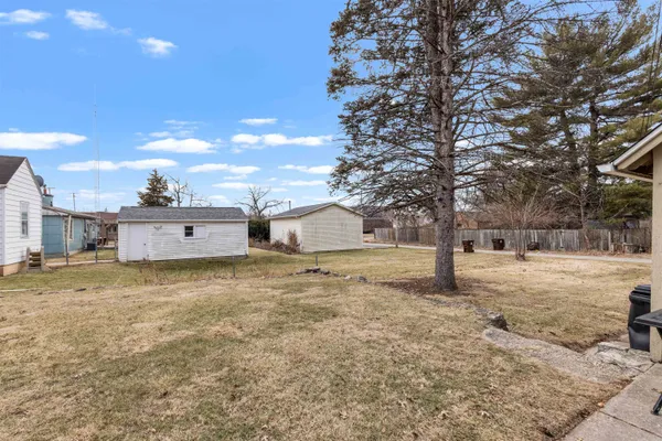 a view of a house with a yard covered in snow