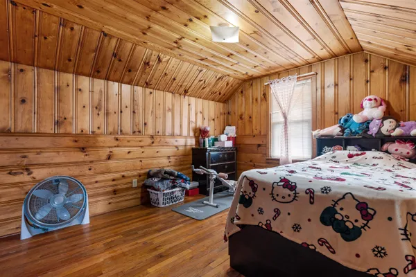 a bedroom with bed and a window