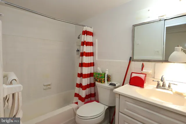 a bathroom with a sink toilet vanity tub and shower